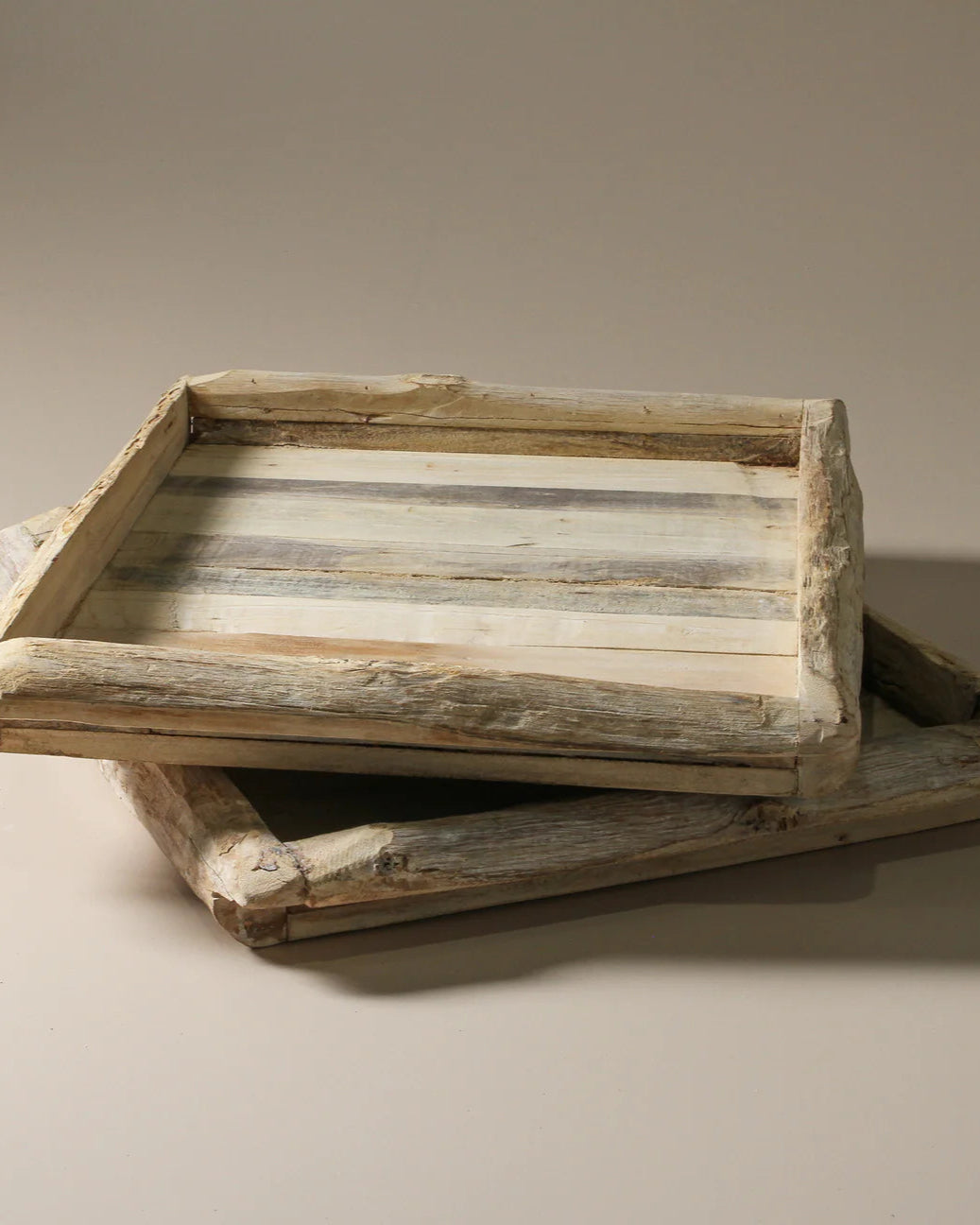 Wooden tray with a rustic design on a beige background